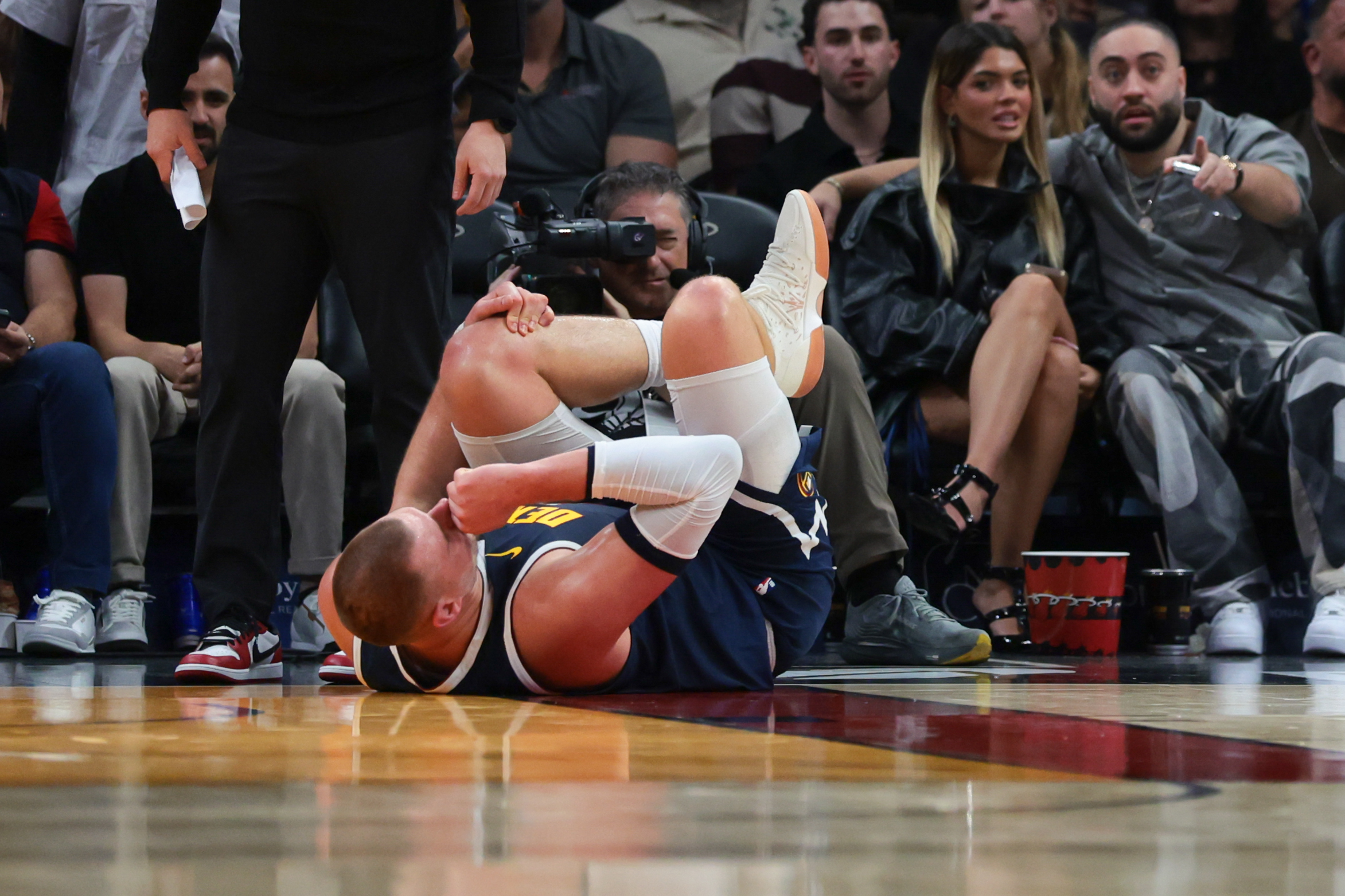 Denver Nuggets center Nikola Jokic (15) holds his knee after an injury as we break down the latest NBA MVP odds.