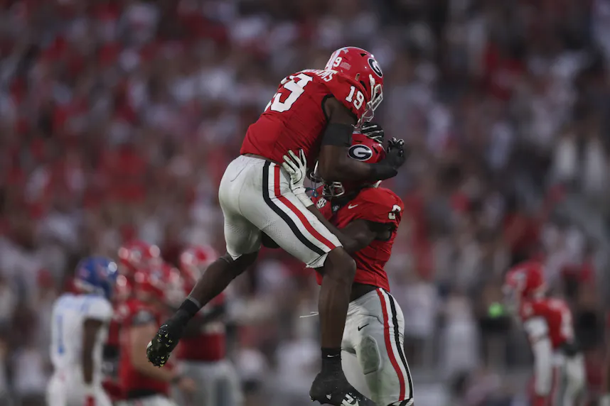 Georgia Bulldogs linebacker Justin Williams (19) and linebacker Chris Cole (9) react as part of our Georgia vs. Florida Prediction & Opening Odds.