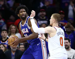 Joel Embiid of the Philadelphia 76ers is guarded by Donte DiVincenzo of the New York Knicks, and we offer our top Knicks vs. 76ers player props and expert picks based on the best NBA odds.