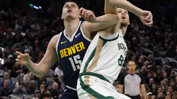 Nikola Jokic #15 of the Denver Nuggets battles Kristaps Porzingis #8 of the Boston Celtics as we look at the latest 2024 NBA championship odds