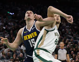 Nikola Jokic #15 of the Denver Nuggets battles Kristaps Porzingis #8 of the Boston Celtics as we look at the latest 2024 NBA championship odds