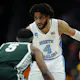 RJ Davis of the North Carolina Tar Heels handles the ball against Tre Holloman of the Michigan State Spartans during the second round of the NCAA Men's Basketball Tournament. We're back North Carolina and Davis in our Sweet 16 expert picks.