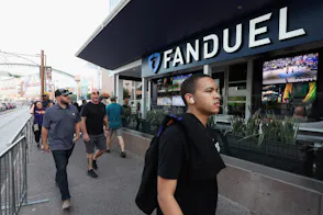 Fans walk past a Fanduel sports betting location as we look at FanDuel's takeover of GamBetDC