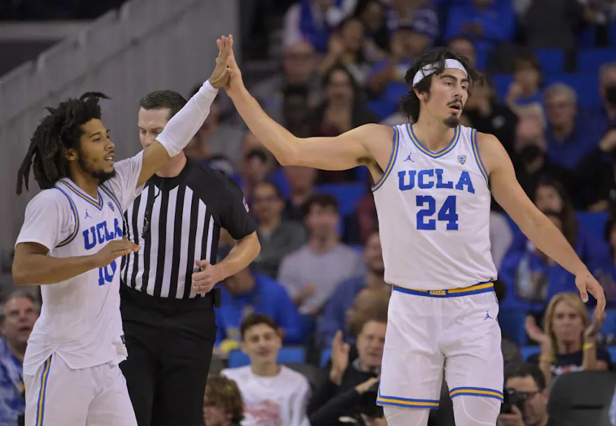 Tyger Campbell #10 and Jaime Jaquez Jr. #24 of the UCLA Bruins high five as we look at the conference championship odds.