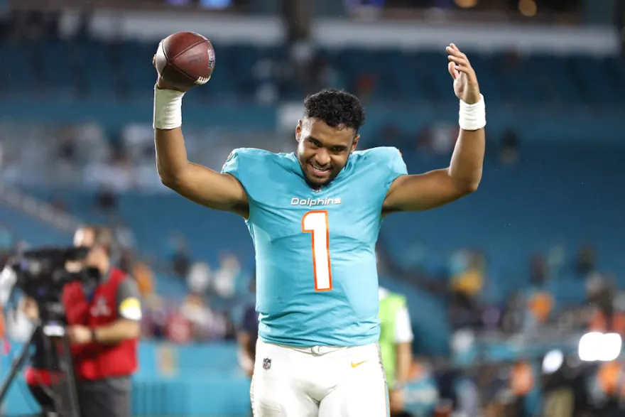 Tua Tagovailoa of the Miami Dolphins celebrates after defeating the Baltimore Ravens, and we offer our top NFL MVP predictions based on the best NFL odds.