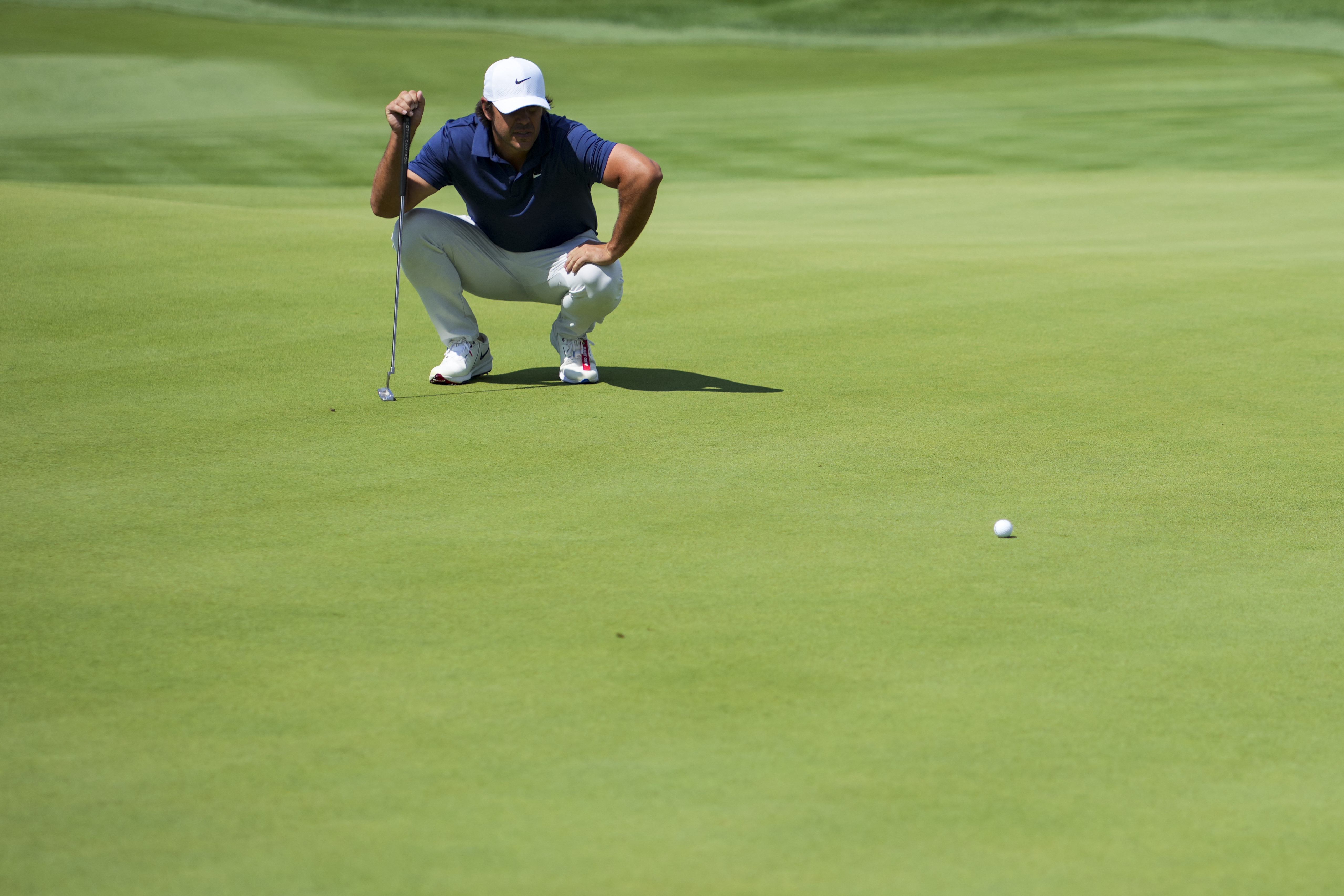 Brooks Koepka eyes a putt as we break down our Farmers Open long shot picks & sleepers.