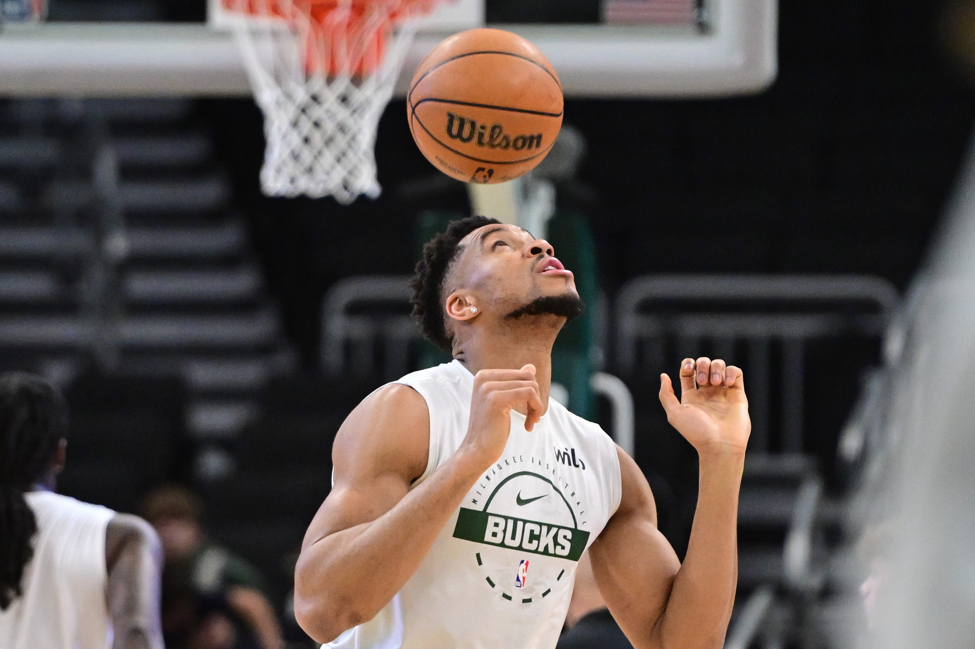 Milwaukee Bucks forward Giannis Antetokounmpo bounces the ball on his head while we look at his partnership with Kalshi.