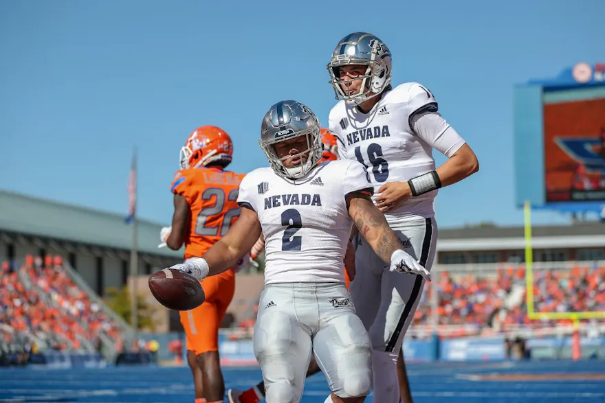 Running back Devonte Lee and quarterback Nate Cox of the Nevada Wolf Pack during first-half action against the Boise State Broncos.