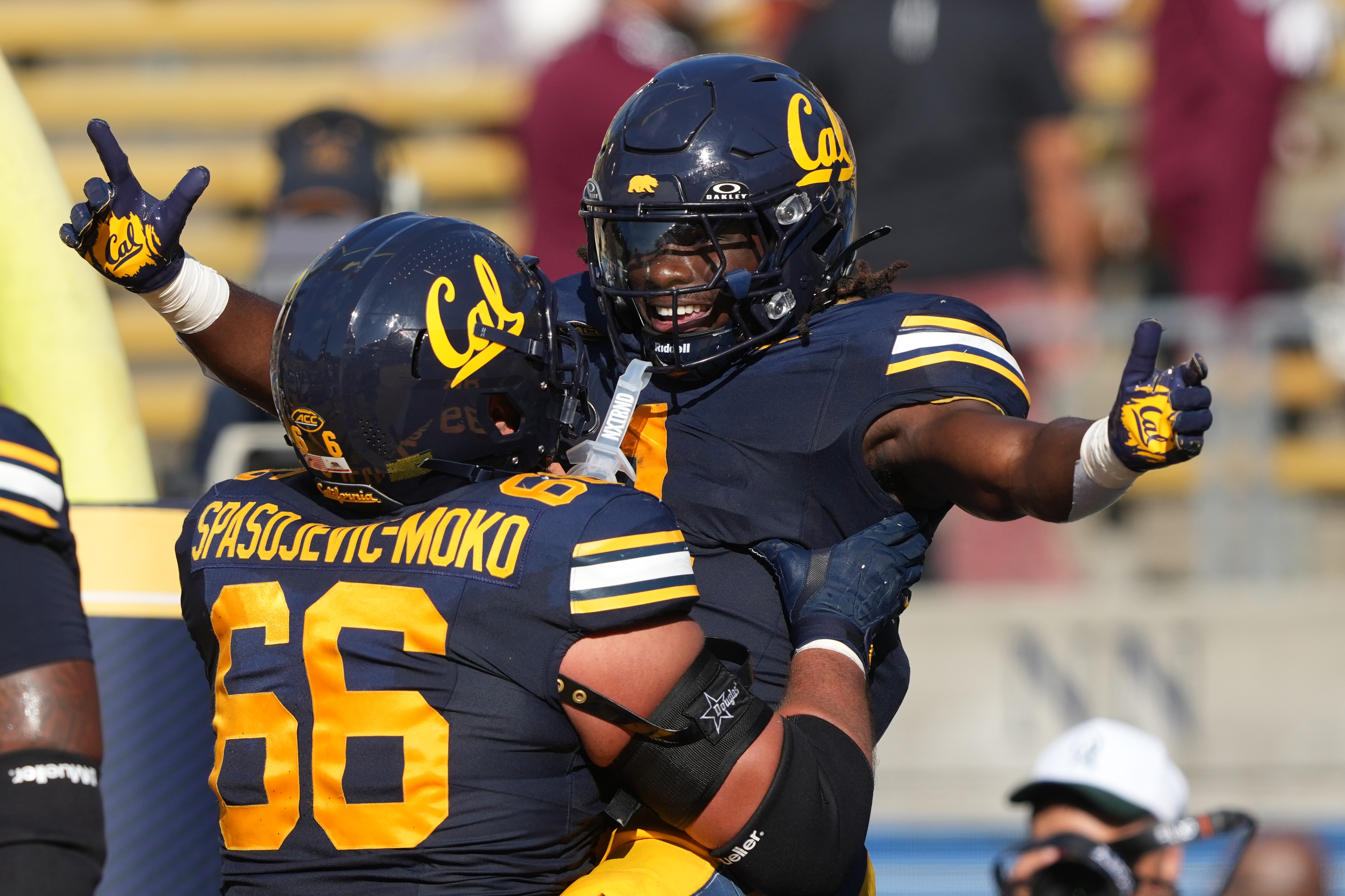 Cal running back Kendrick Raphael (right) celebrates with a teammate as we offer our Cal vs. Hawaii player props for the Hawaii Bowl.