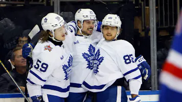 Auston Matthews of the Toronto Maple Leafs celebrates his third-period goal against the New York Rangers and is joined by Tyler Bertuzzi and William Nylander at Madison Square Garden as we look at our Sabres-Maple Leafs NHL player props.