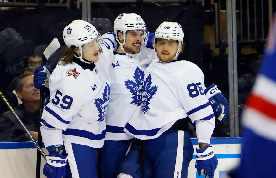 Auston Matthews of the Toronto Maple Leafs celebrates his third-period goal against the New York Rangers and is joined by Tyler Bertuzzi and William Nylander at Madison Square Garden as we look at our Sabres-Maple Leafs NHL player props.