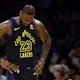 LeBron James #23 of the Los Angeles Lakers looks down as we look at the latest 2024 NBA Play-In Tournament odds.