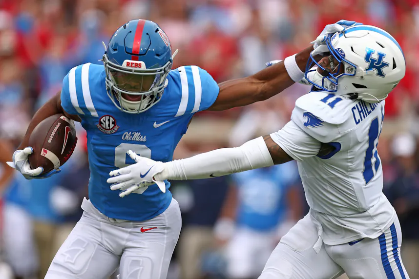 Ole Miss wide receiver Tre Harris stiff-arms Kentucky defensive back Zion Childress. We're backing Harris in our Week 6 college football expert picks.
