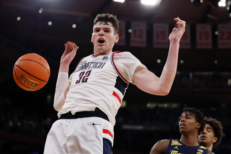 Donovan Clingan of the UConn Huskies reacts after dunking the ball, and we offer our top March Madness player props for Friday based on the best March Madness odds.
