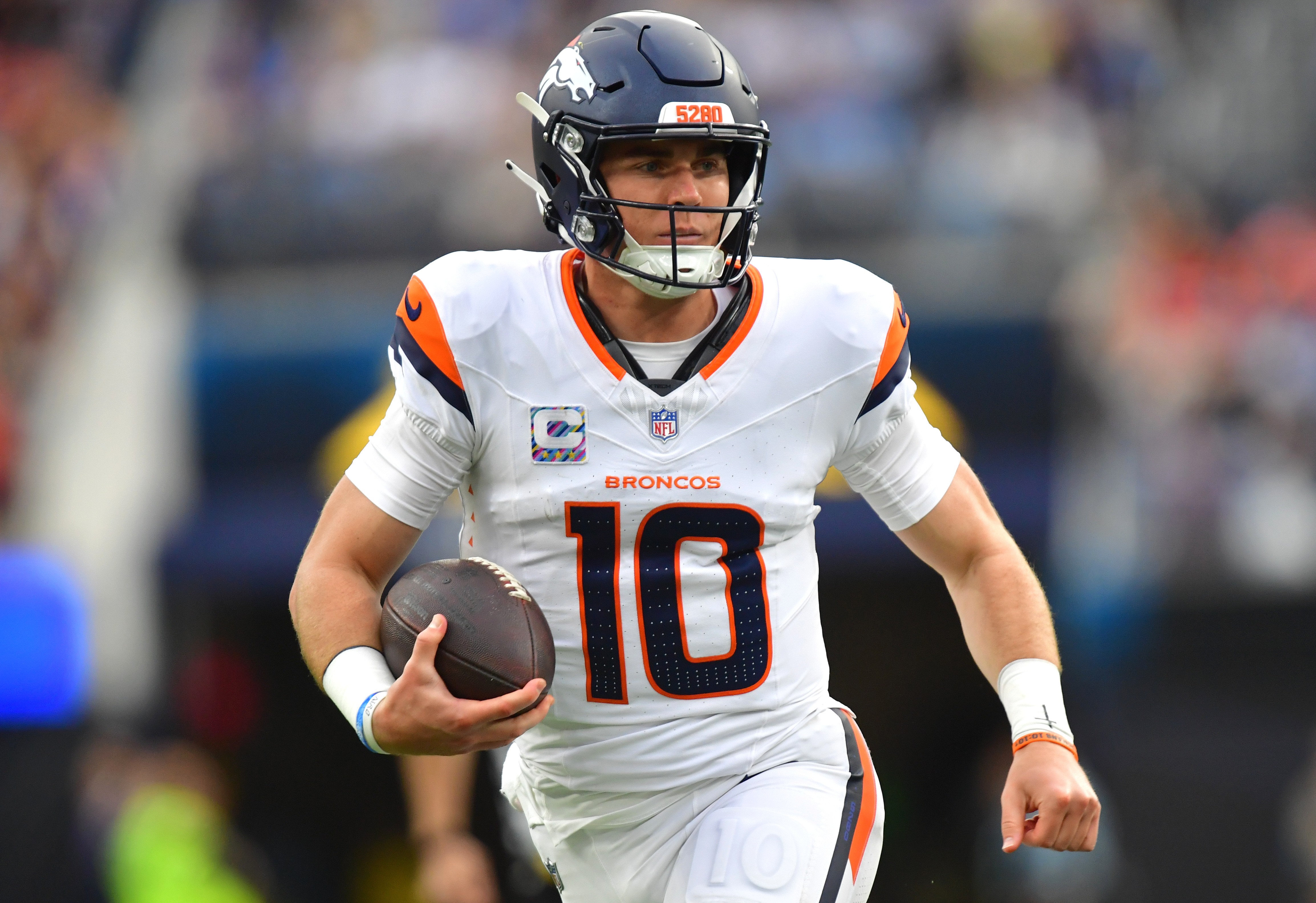 Denver Broncos quarterback Bo Nix (10) runs the ball against the Los Angeles Chargers as we make our best Seahawks vs. Broncos same-game parlay.
