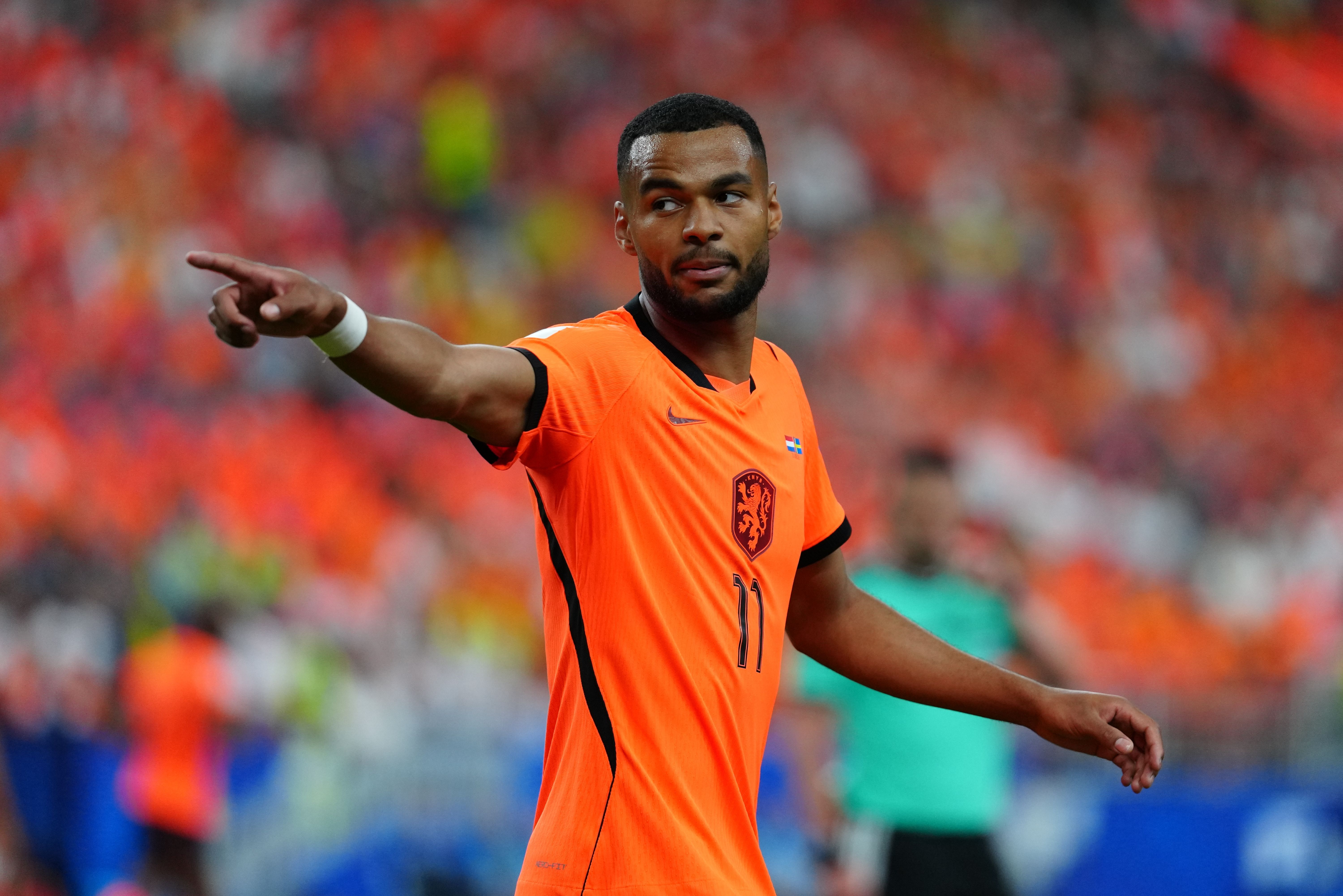 Cody Gakpo of the Netherlands points as we make our best Tunisia vs. Netherlands predictions.