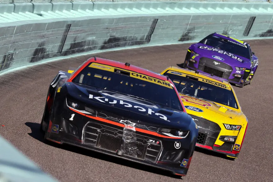 Ross Chastain, driver of the #1 Kubota Chevrolet, Joey Logano, driver of the #22 Shell Pennzoil Ford, and Brad Keselowski, driver of the #6 Violet Defense Ford, race during the NASCAR Cup Series Dixie Vodka 400 at Homestead-Miami Speedway.