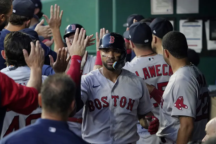 Xander Bogaerts of the Boston Red Sox is congratulated by teammates after scoring a J.D. Martinez two-run double in the fourth inning against the Kansas City Royals.