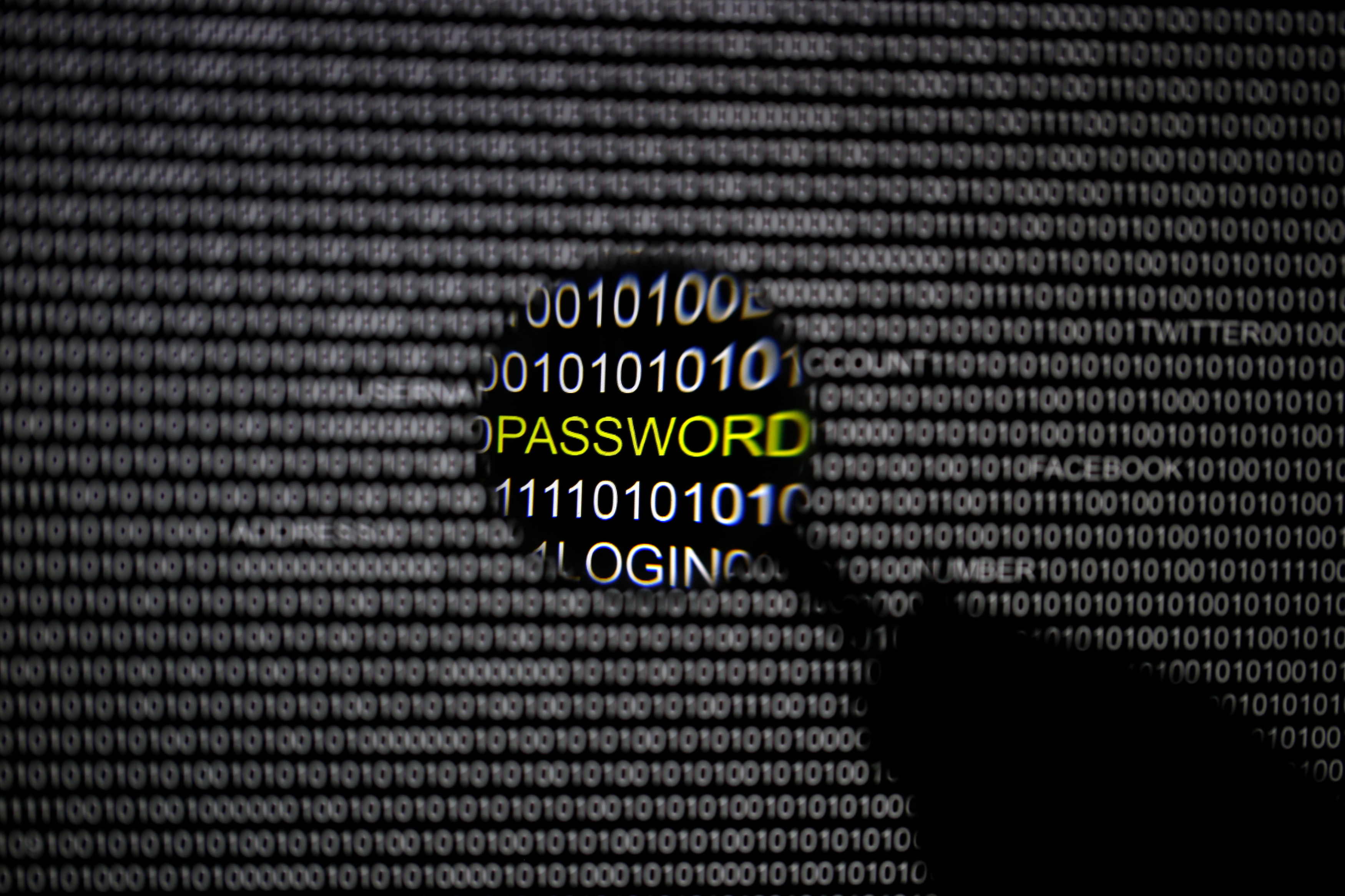 A magnifying glass is held in front of a computer screen as we look at Polymarket investigating Kalshi for corporate espionage.