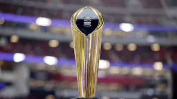 The College Football Playoff National Championship trophy is displayed as we look at the college football bowl odds and info for 2023