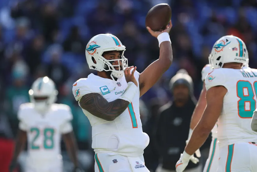 Tua Tagovailoa of the Miami Dolphins warms up before a game against the Baltimore Ravens, and we offer our top NFL upset predictions for Week 18 based on the best NFL odds.