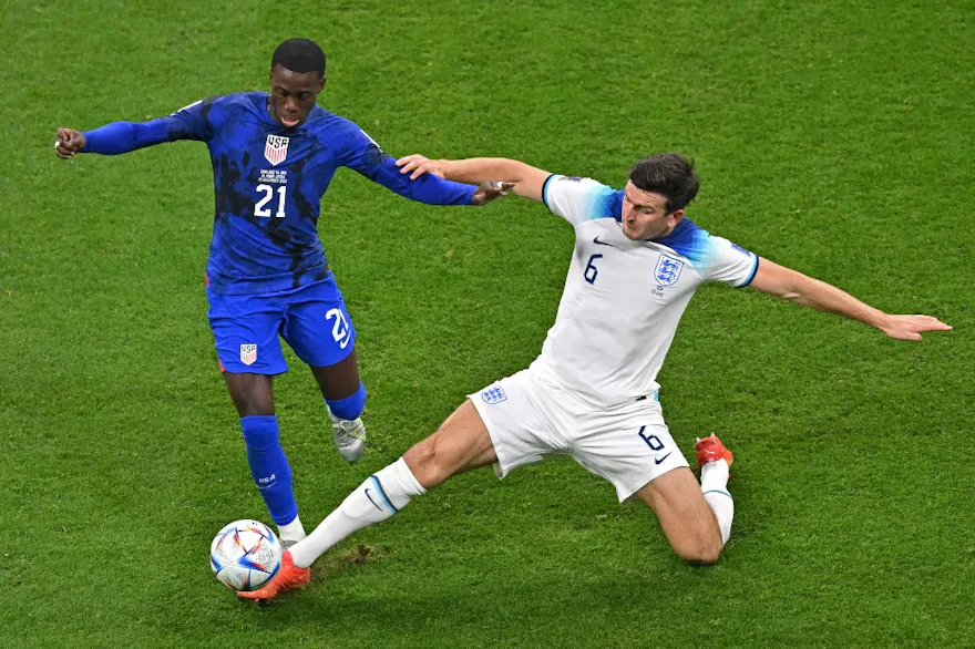 USA's forward #21 Timothy Weah fights for the ball with England's defender #06 Harry Maguire during the Qatar 2022 World Cup Group B football match between England and USA at the Al-Bayt Stadium in Al Khor, north of Doha on November 25, 2022.