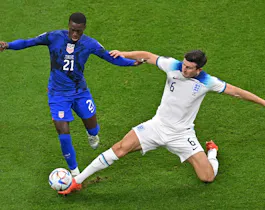 USA's forward #21 Timothy Weah fights for the ball with England's defender #06 Harry Maguire during the Qatar 2022 World Cup Group B football match between England and USA at the Al-Bayt Stadium in Al Khor, north of Doha on November 25, 2022.