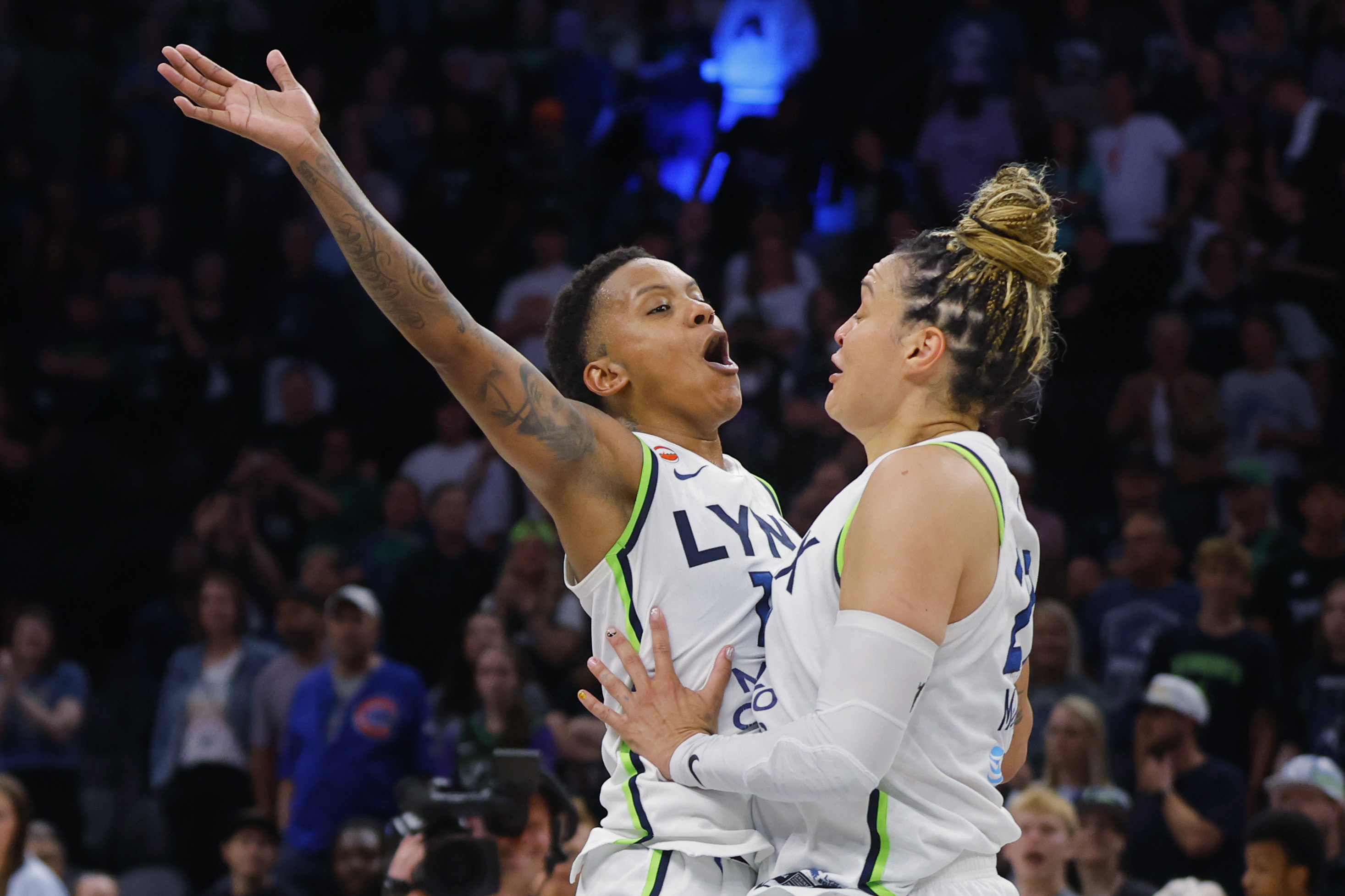 Minnesota Lynx guards Courtney Williams - who's featured in my Storm vs. Lynx prediction - and Kayla McBride (21) celebrate after defeating the Golden State Valkyries at Target Center.