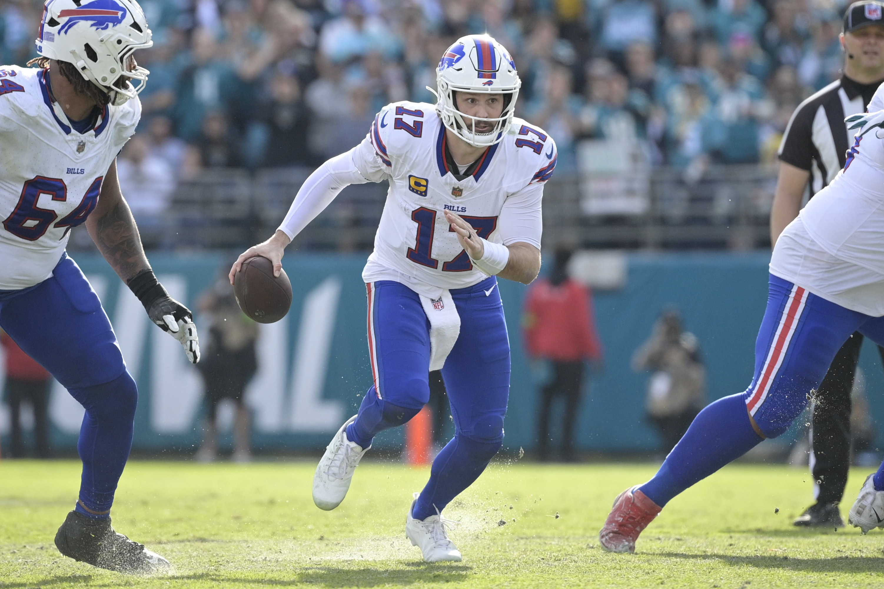 Josh Allen runs with the ball during the first half as we provide our Bills vs. Broncos prediction, picks, and best bets.