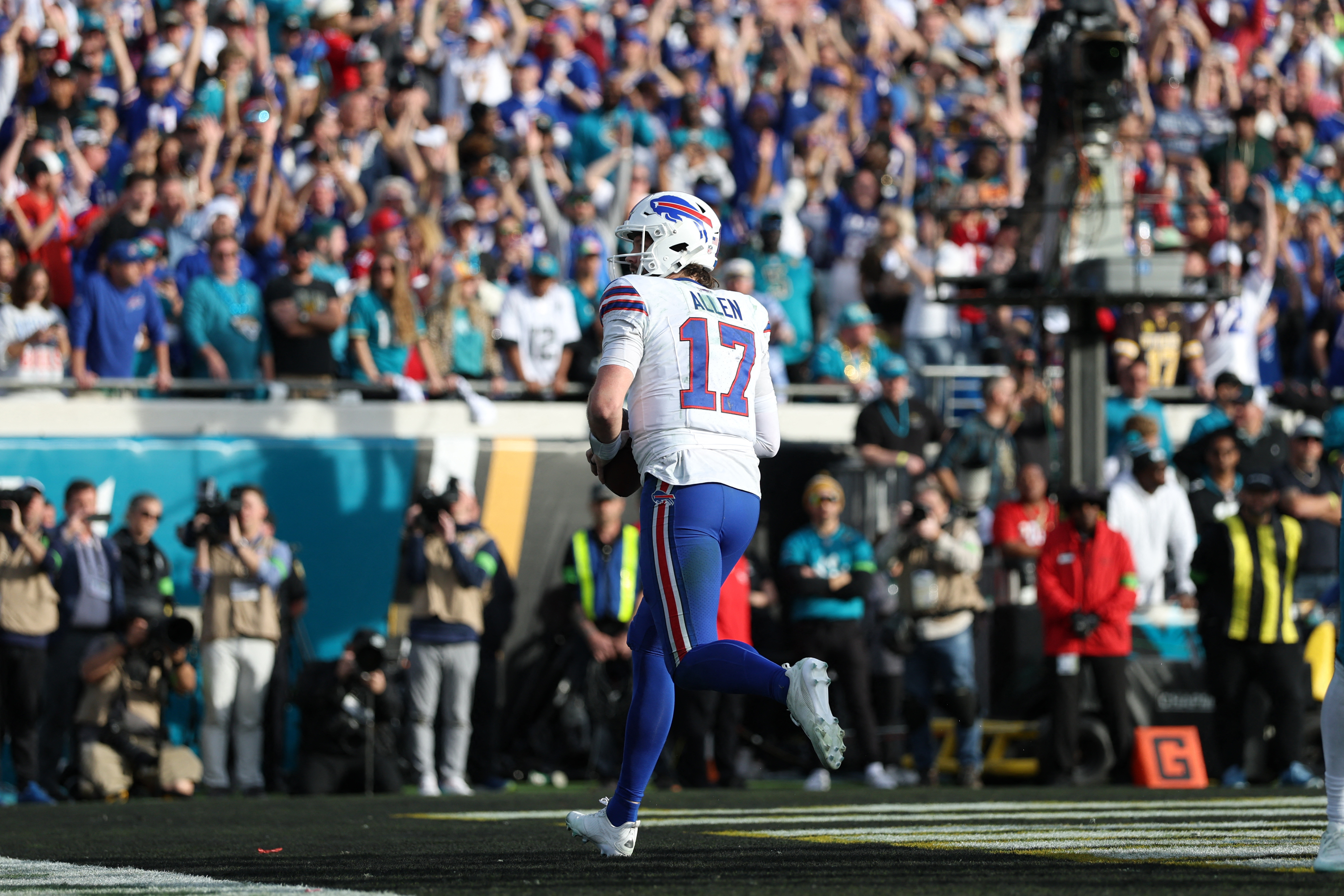 Buffalo Bills quarterback Josh Allen (17) scores a touchdown as we break down our NFL picks against the spread divisional round.