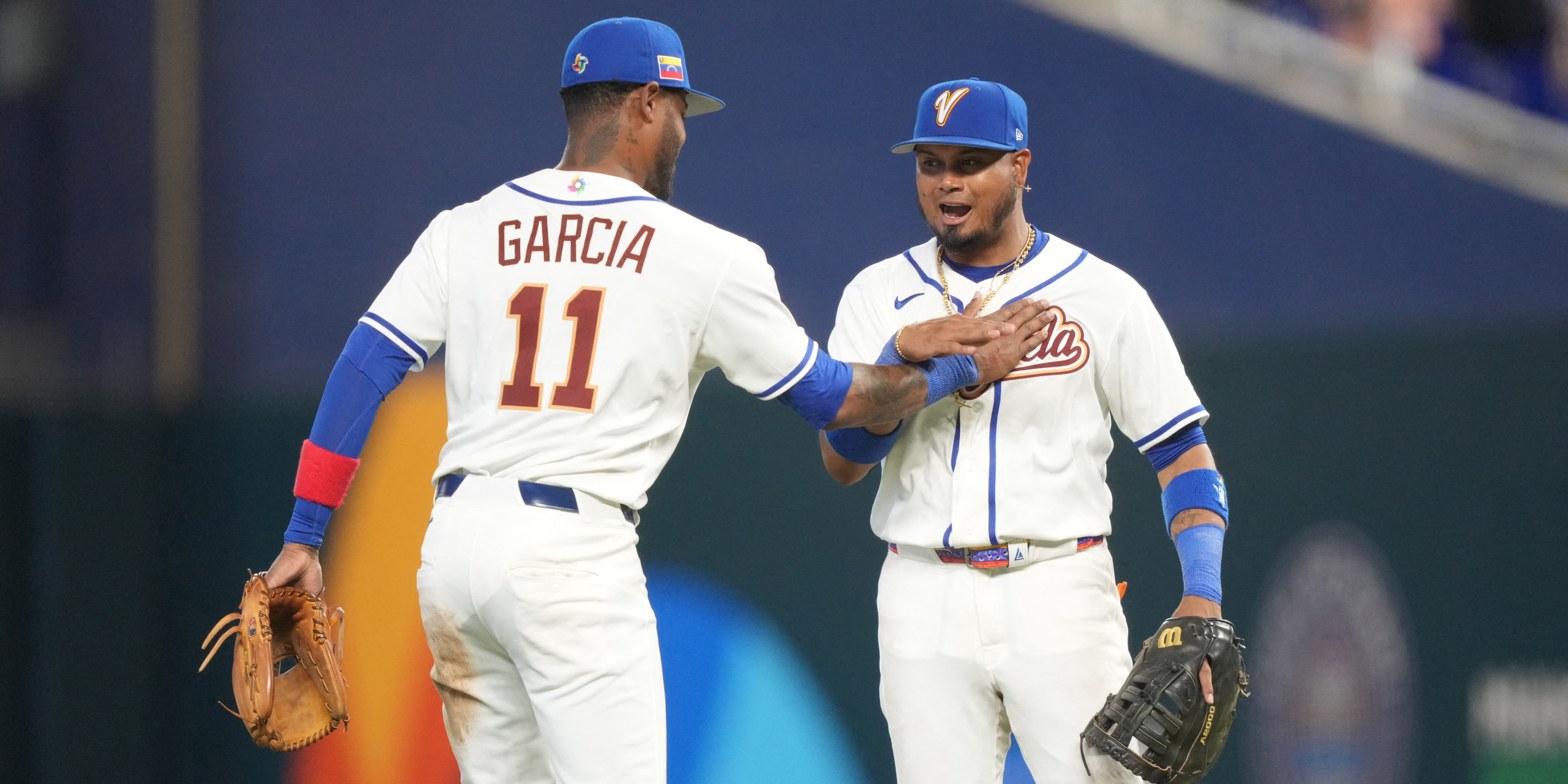 Venezuela third baseman Maikel Garcia (11) and first baseman Luis Arraez (2) celebrate as we break down our Israel vs. Venezuela predictions tonight.