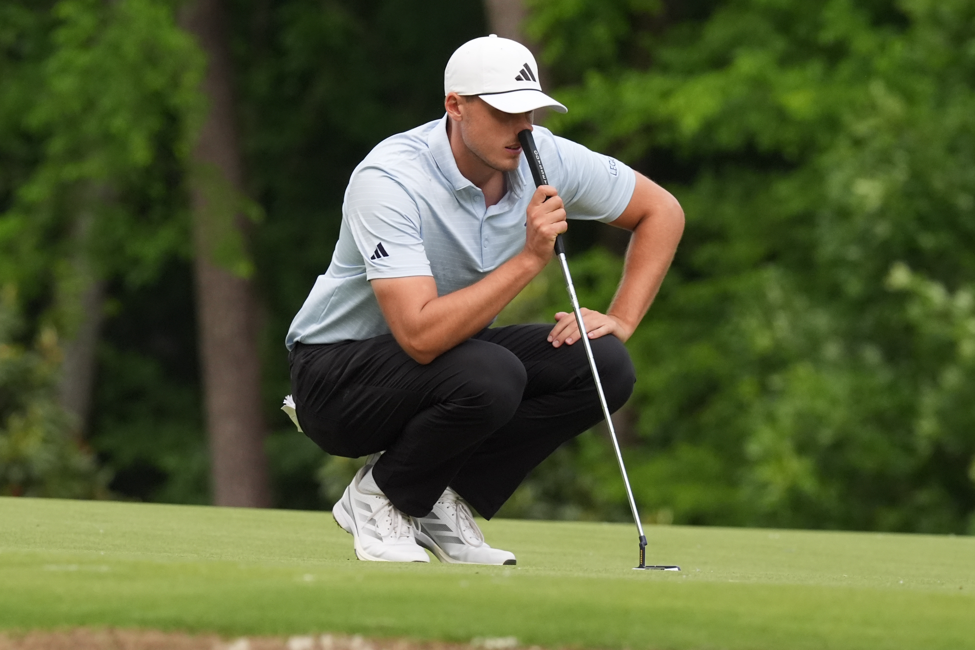 Ludvig Aberg - who's featured in our PGA Championship AI Predictions - looks over his line. 