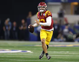 Caleb Williams of the USC Trojans looks to throw against the Tulane Green Wave in the first half of the Goodyear Cotton Bowl Classic on January 2, 2023 at AT&T Stadium in Arlington, Texas.