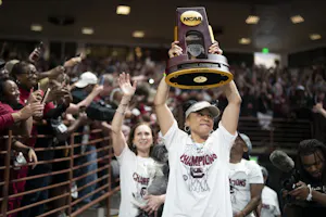 South Carolina coach Dawn Staley raises the NCAA Women's Basketball Championship trophy at a celebration at the Colonial Life Arena in Columbia, South Carolina. South Carolina opened as the favorite to repeat by the 2025 women's March Madness odds.
