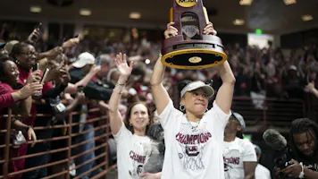 South Carolina coach Dawn Staley raises the NCAA Women's Basketball Championship trophy at a celebration at the Colonial Life Arena in Columbia, South Carolina. South Carolina opened as the favorite to repeat by the 2025 women's March Madness odds.