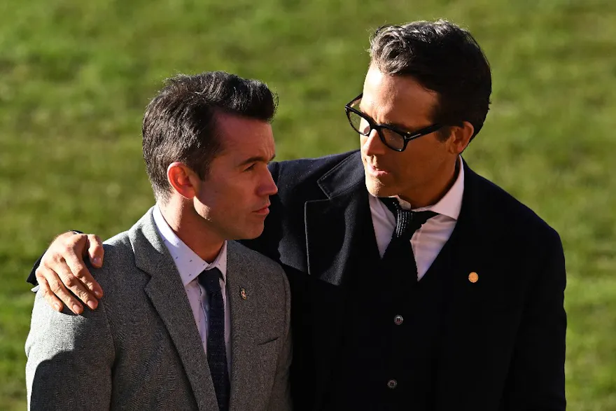 Wrexham AFC's Co-Chairmen, Ryan Reynolds and Rob McElhenney wait on the pitch and we offer new U.S. bettors our exclusive Caesars promo code ahead of Wrexham vs. Wigan.