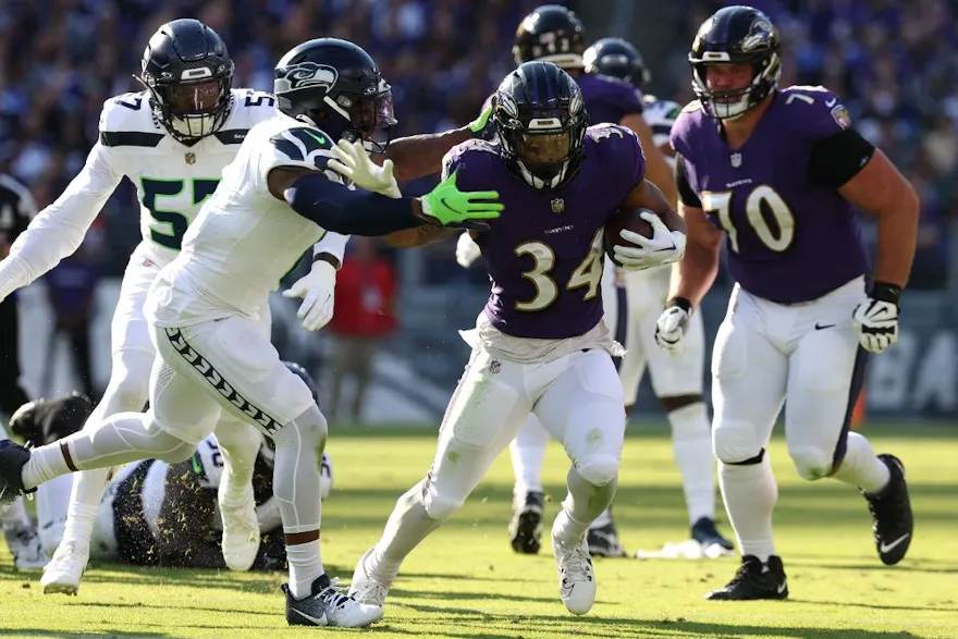 Keaton Mitchell of the Baltimore Ravens is tackled as we look at the best Rams vs. Ravens player props.