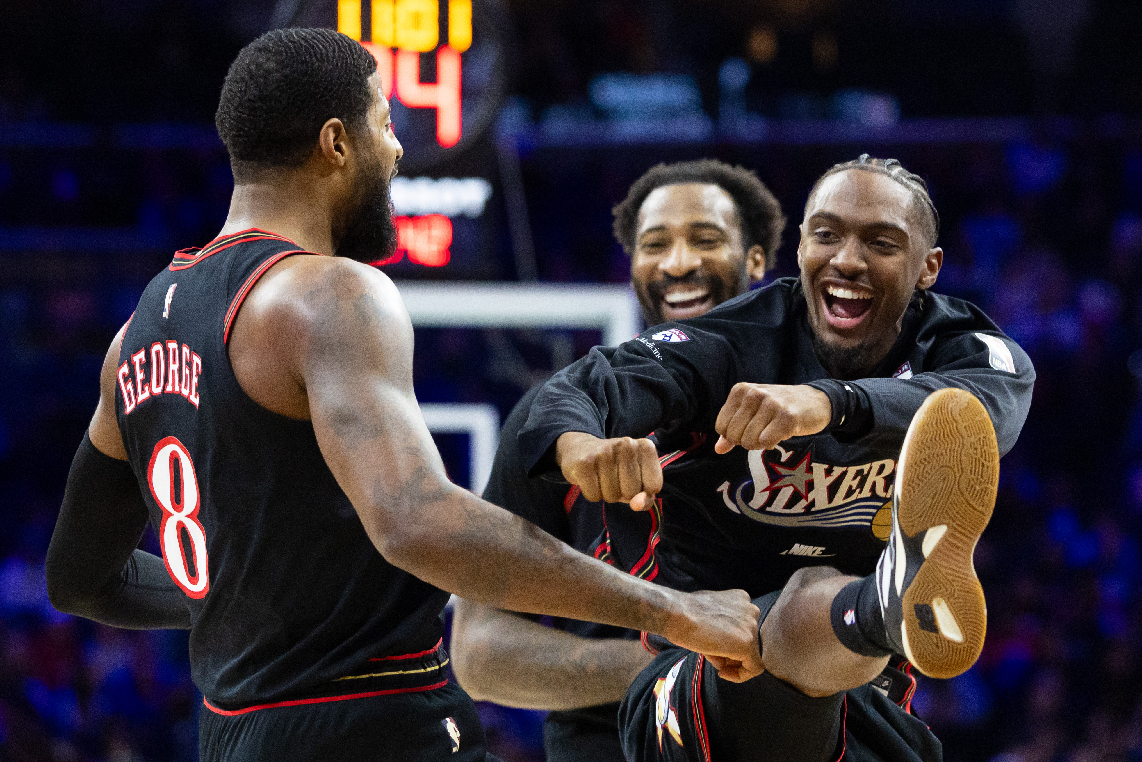 Philadelphia 76ers forward Paul George (8) celebrates with guard Tyrese Maxey (0), and both are featured in our 76ers vs. Bulls player props.