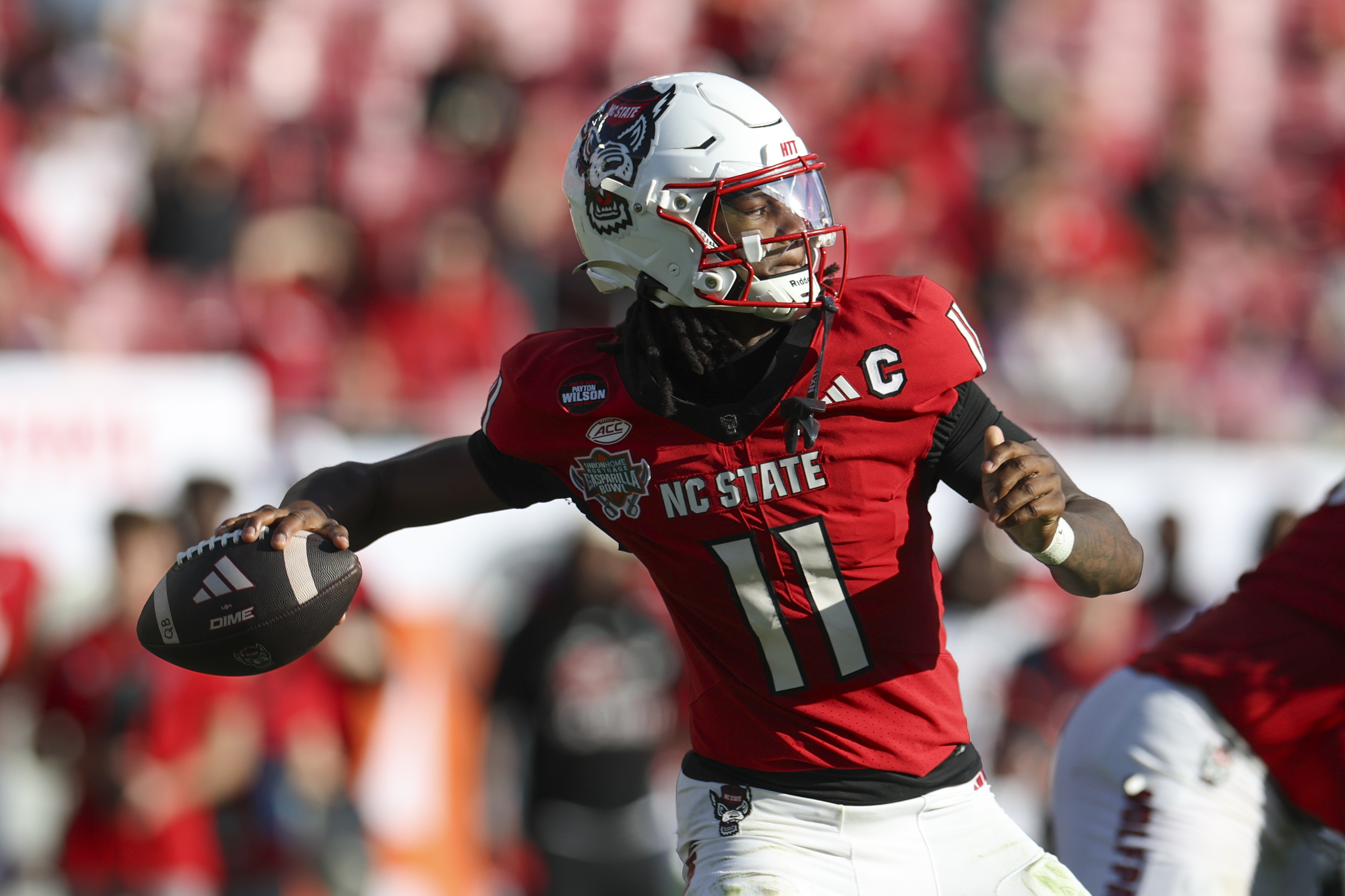 NC State Wolfpack quarterback CJ Bailey (11) throws a pass as we break down our NC State vs. Virginia predictions.