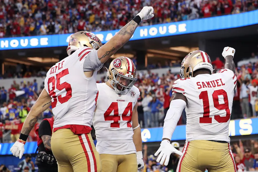 Deebo Samuel of the San Francisco 49ers reacts with teammates Kyle Juszczyk and George Kittle after scoring a touchdown in the second quarter against the Los Angeles Rams in the NFC Championship Game at SoFi Stadium.