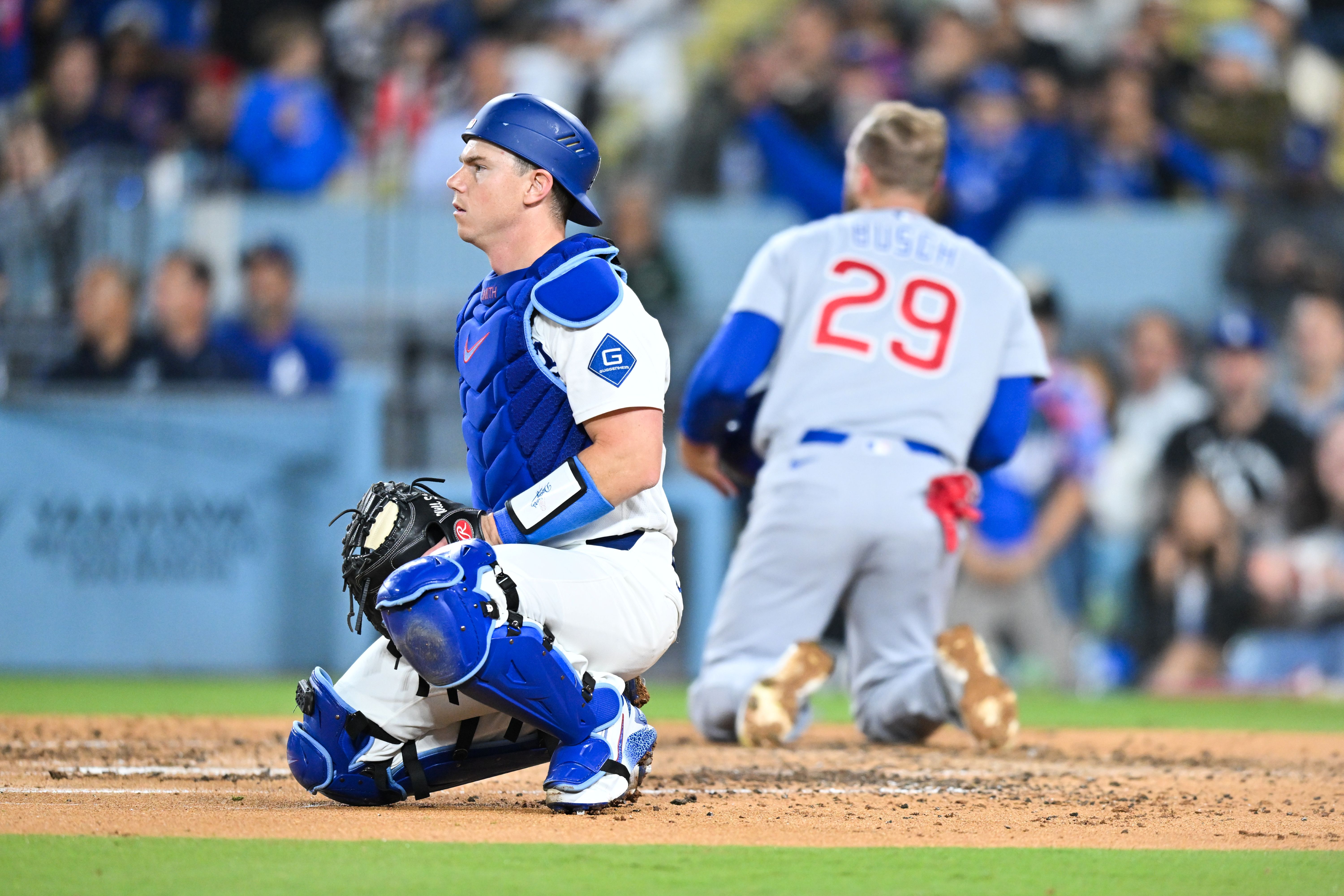 Los Angeles Dodgers catcher Will Smith looks on after tagging Chicago Cubs first baseman Michael Busch, who features in our Cubs vs. Dodgers prediction.