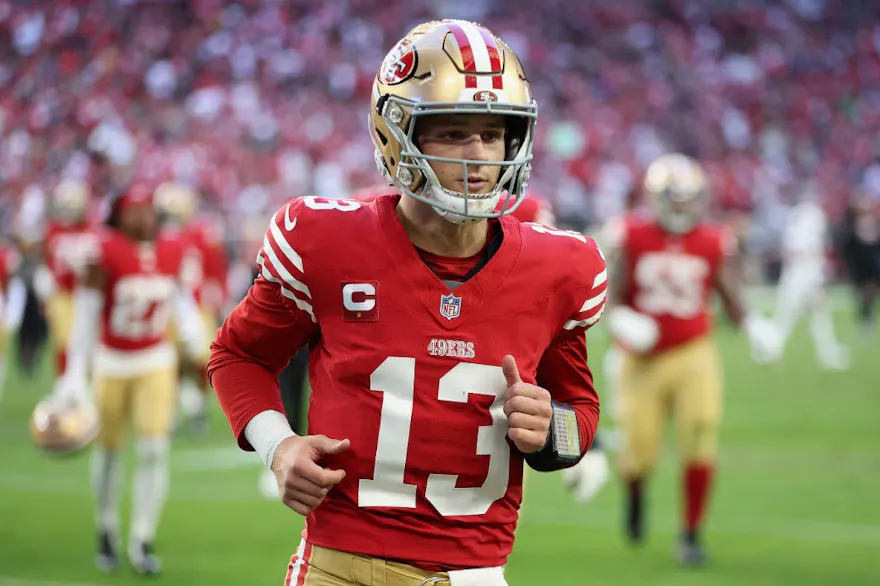 Quarterback Brock Purdy #13 of the San Francisco 49ers runs off the field as we round up our NFL predictions for Christmas Day