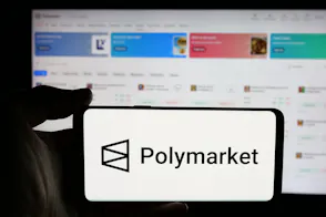 A person is holding a cellphone with the logo of Polymarket as we look at the company's reentry into the US market.