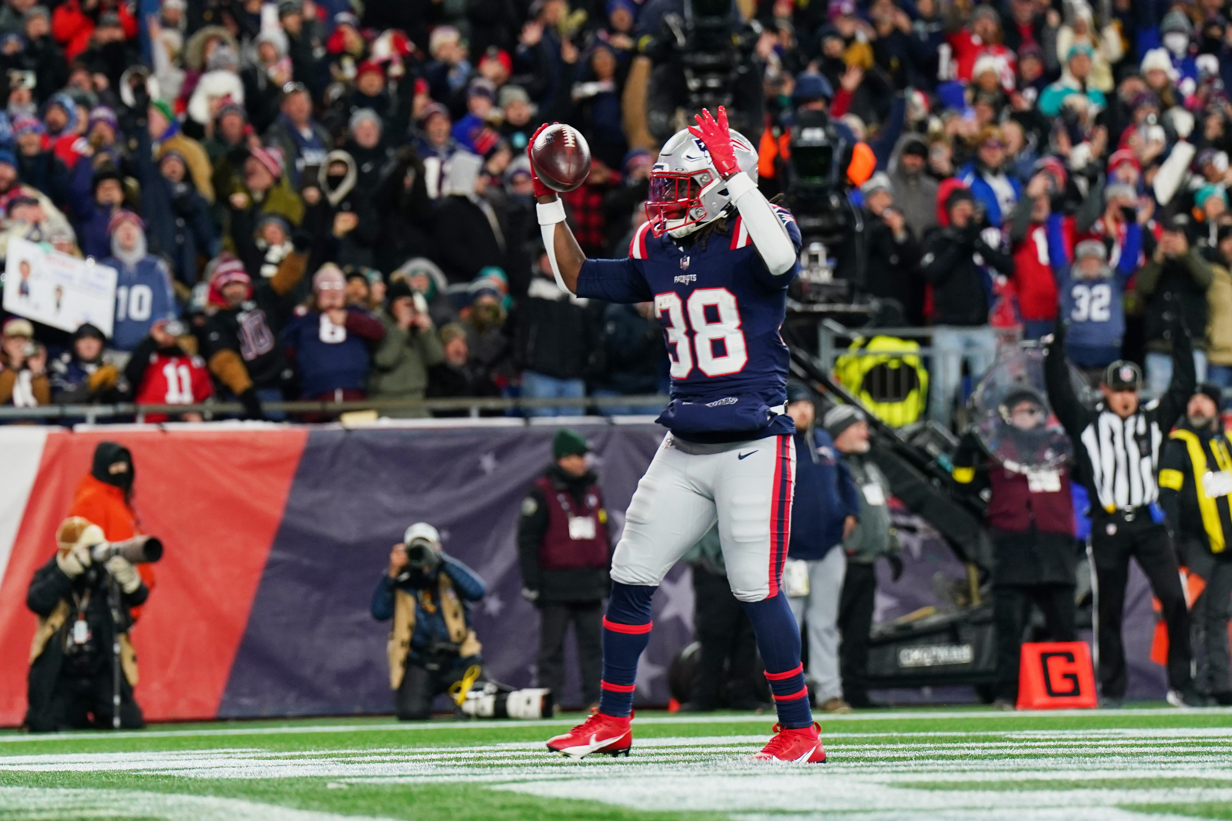 Rhamondre Stevenson reacts after running for a a two-yard touchdown as we offer first touchdown scorer predictions for the Texans vs. Patriots.