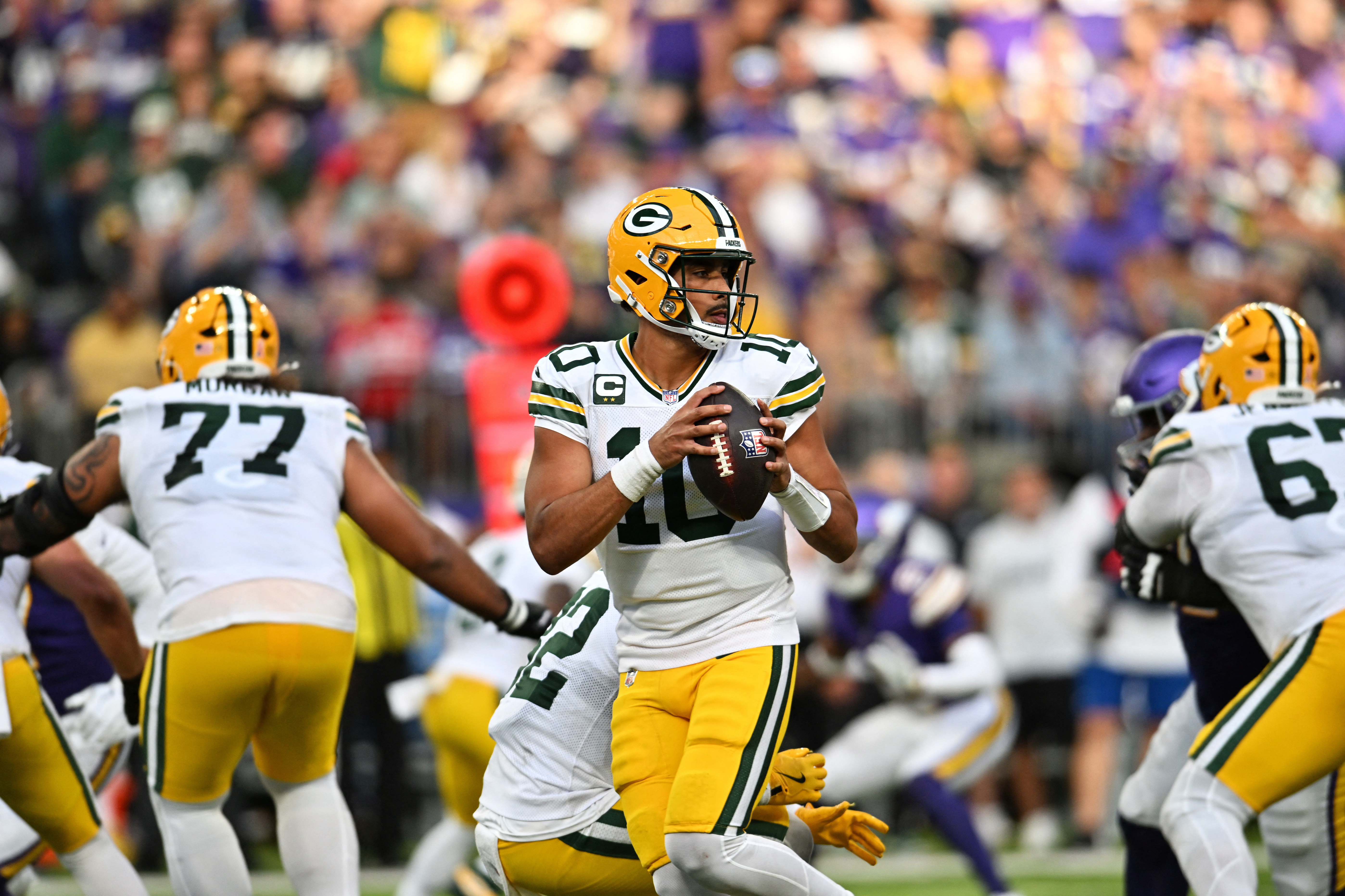 Green Bay Packers quarterback Jordan Love drops back to pass as we provide our Packers vs. Jets prediction.