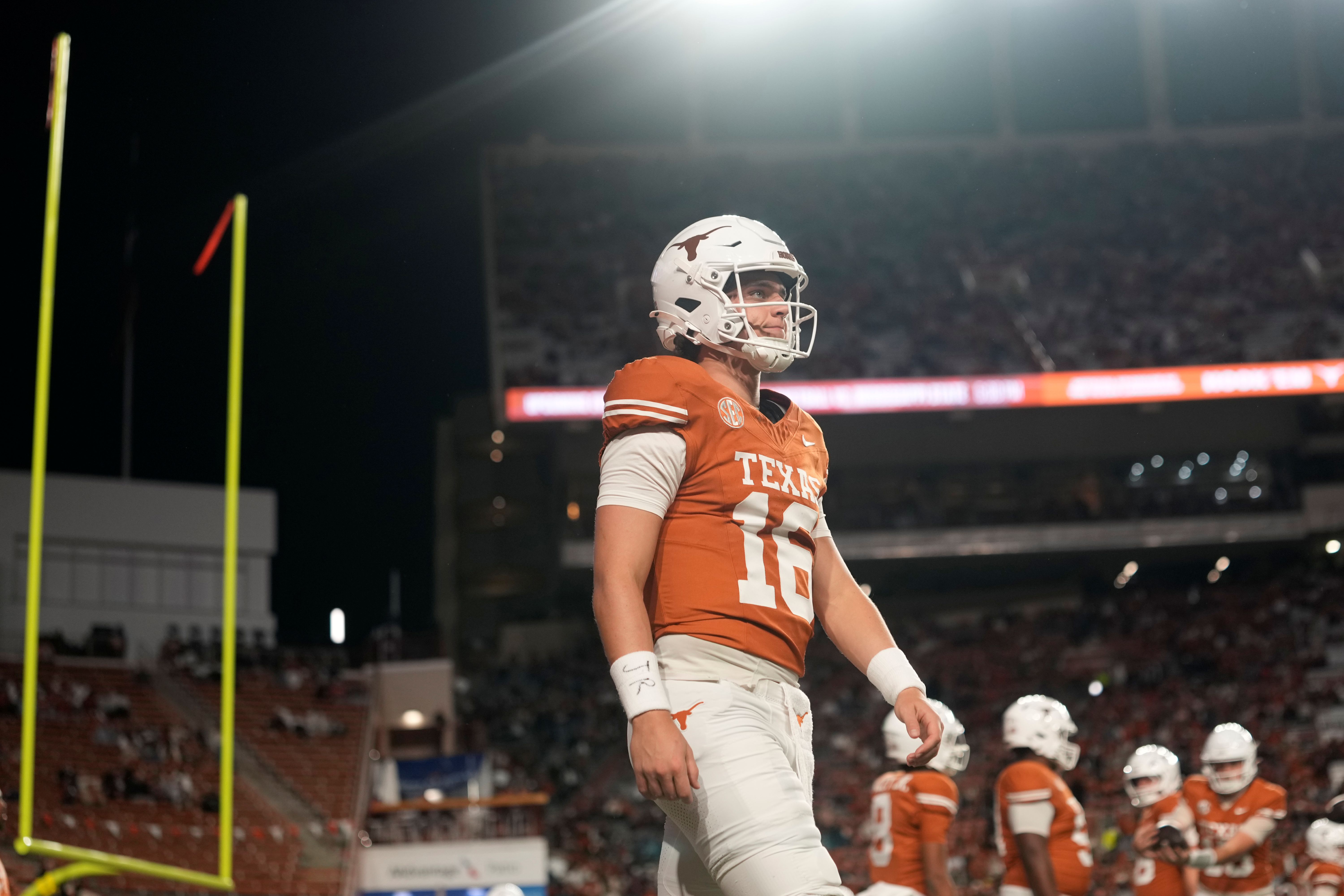 Texas Longhorns quarterback Arch Manning warms up as we make our best Texas State vs. Texas prediction.