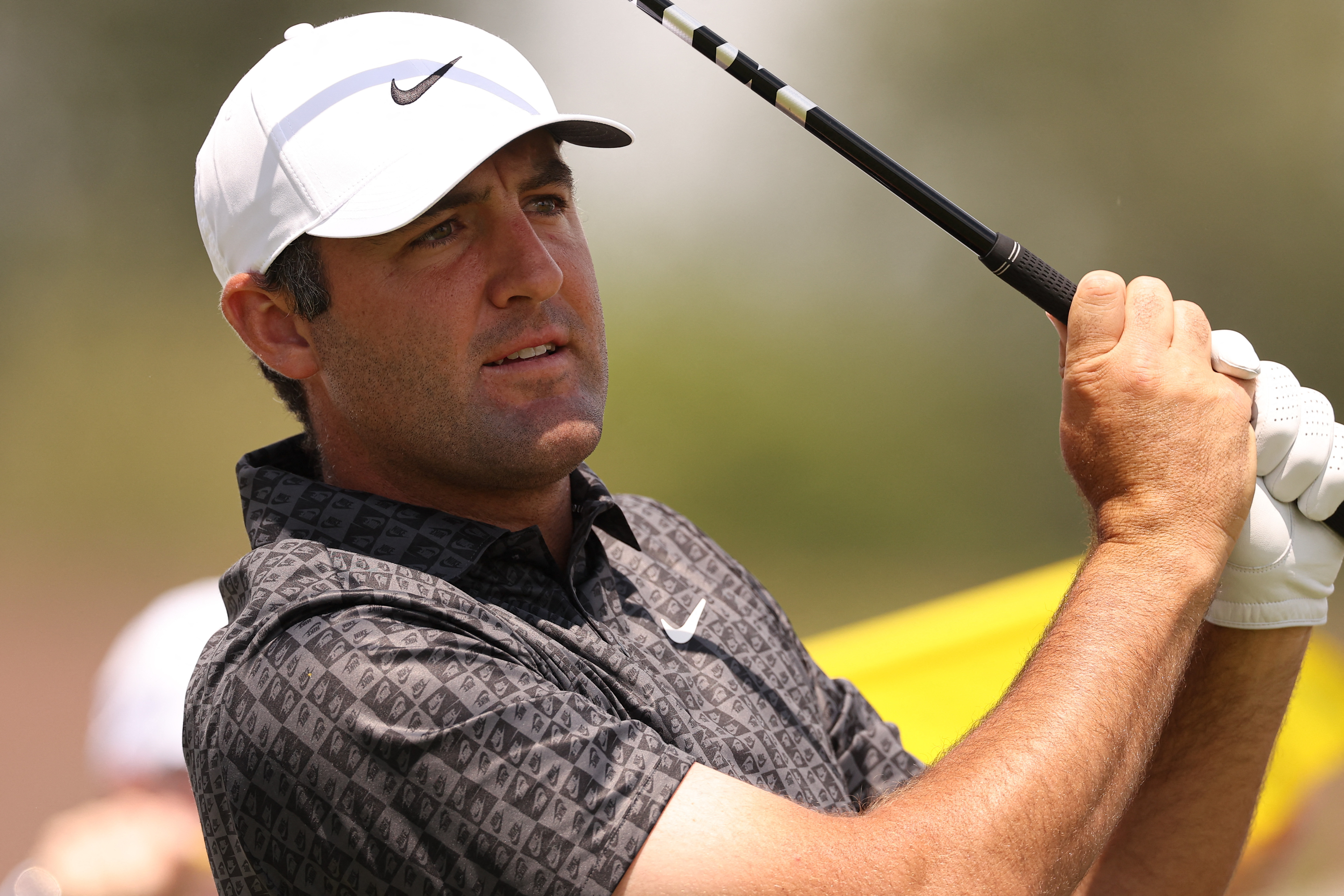 Scottie Scheffler plays a tee shot on the eleventh hole as we break down our PGA Championship first-round leader prediction & odds.