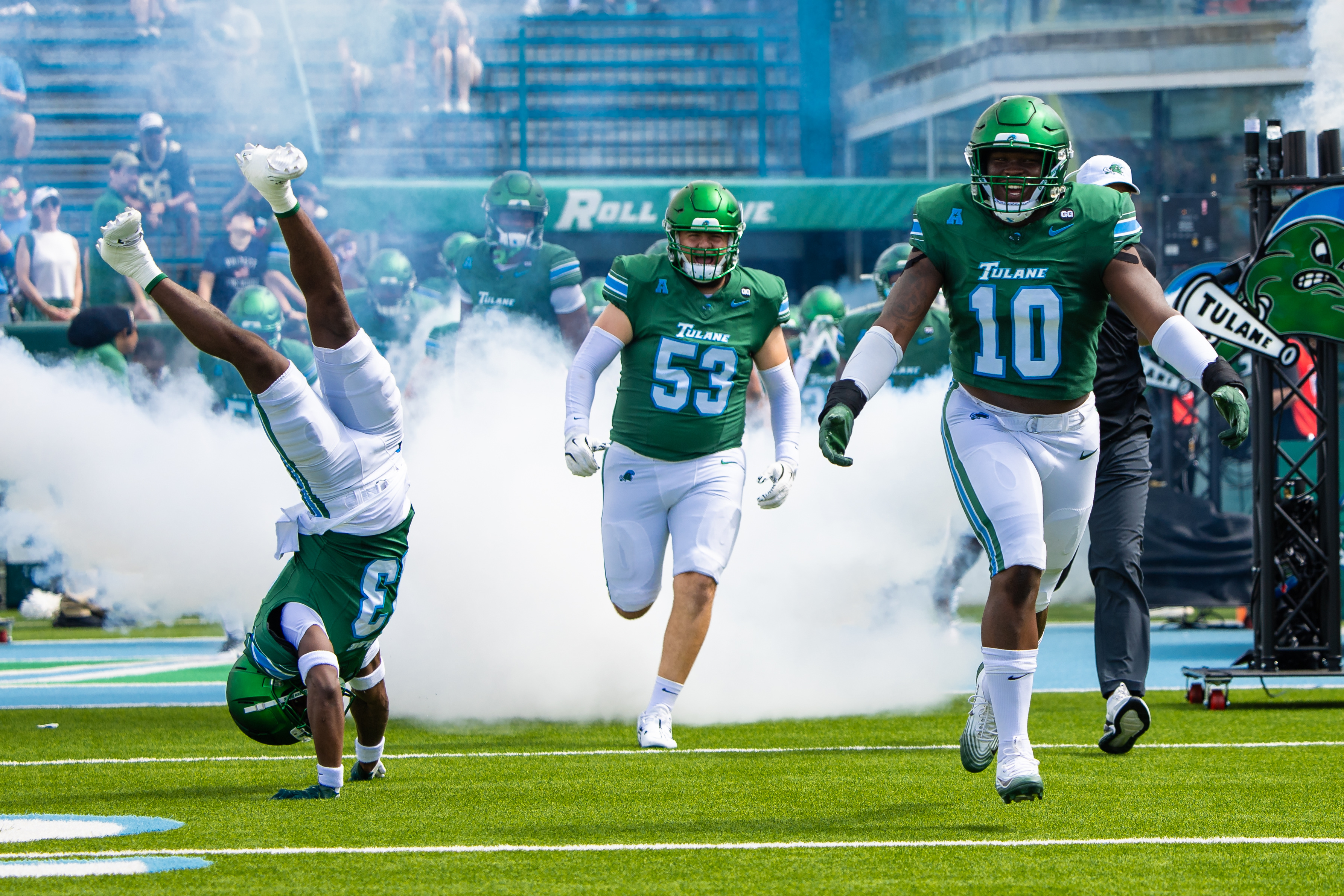 Tulane Green Wave head coach Jon Sumrall runs out the tunnel with defensive end Gerrod Henderson (10) and safety Tavare Smith (13) as part of our Tulane vs. Ole Miss prediction & opening odds.