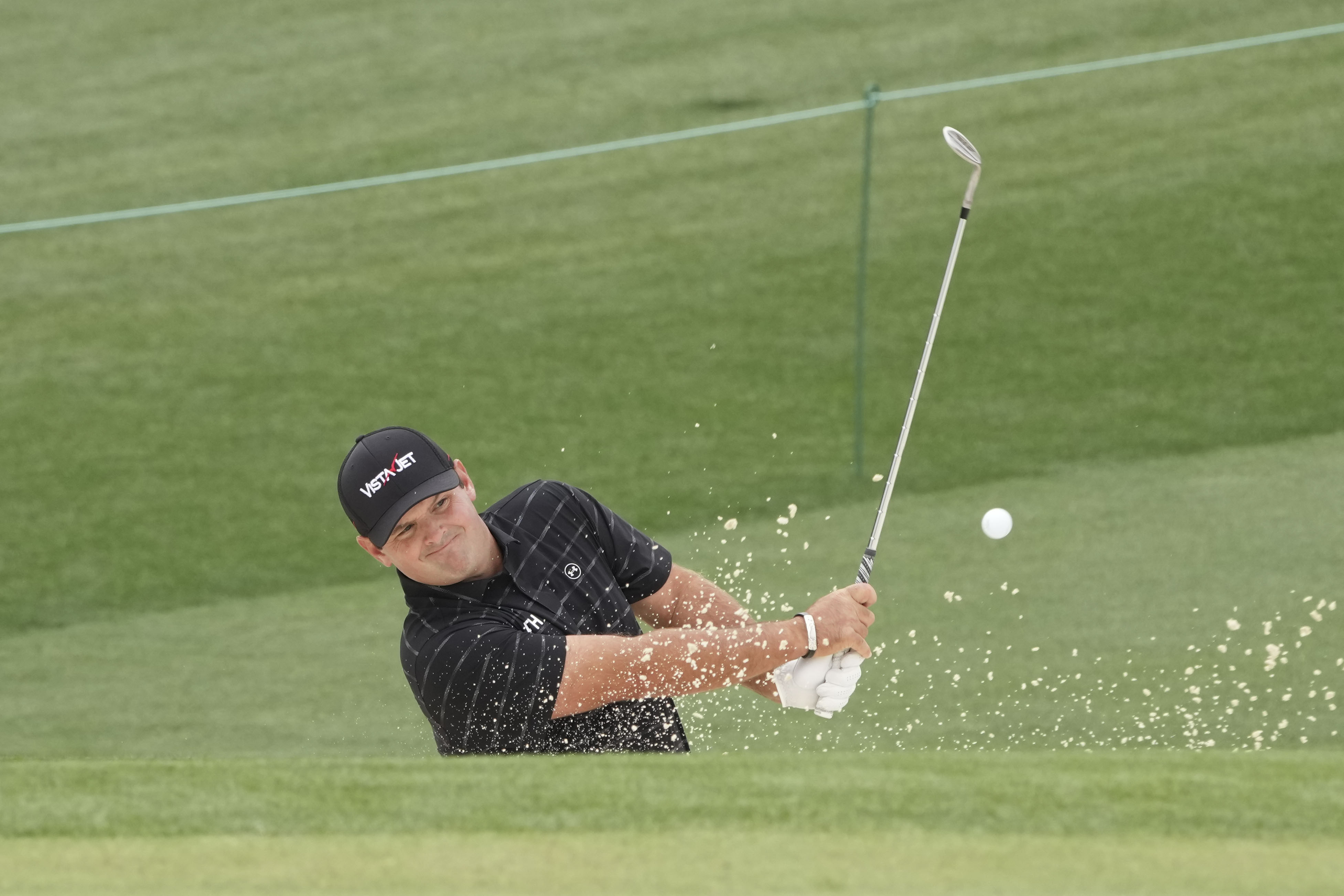 Patrick Reed hits his bunker shot on the second hole during a practice round for the Masters Tournament at Augusta National Golf Course, as we look at our Masters parlay picks