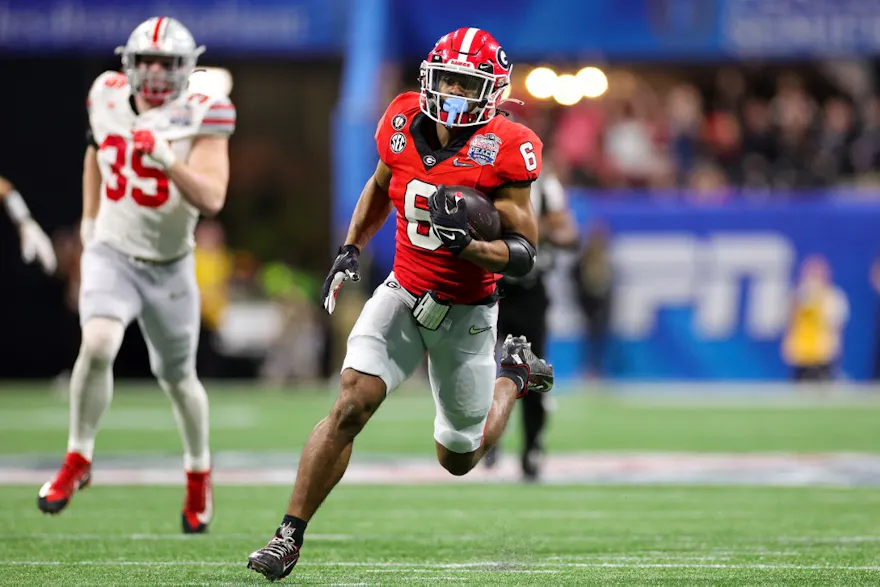 Kenny McIntosh of the Georgia Bulldogs rushes against the Ohio State Buckeyes in the Chick-fil-A Peach Bowl at Mercedes-Benz Stadium on Dec. 31, 2022 in Atlanta, Georgia.